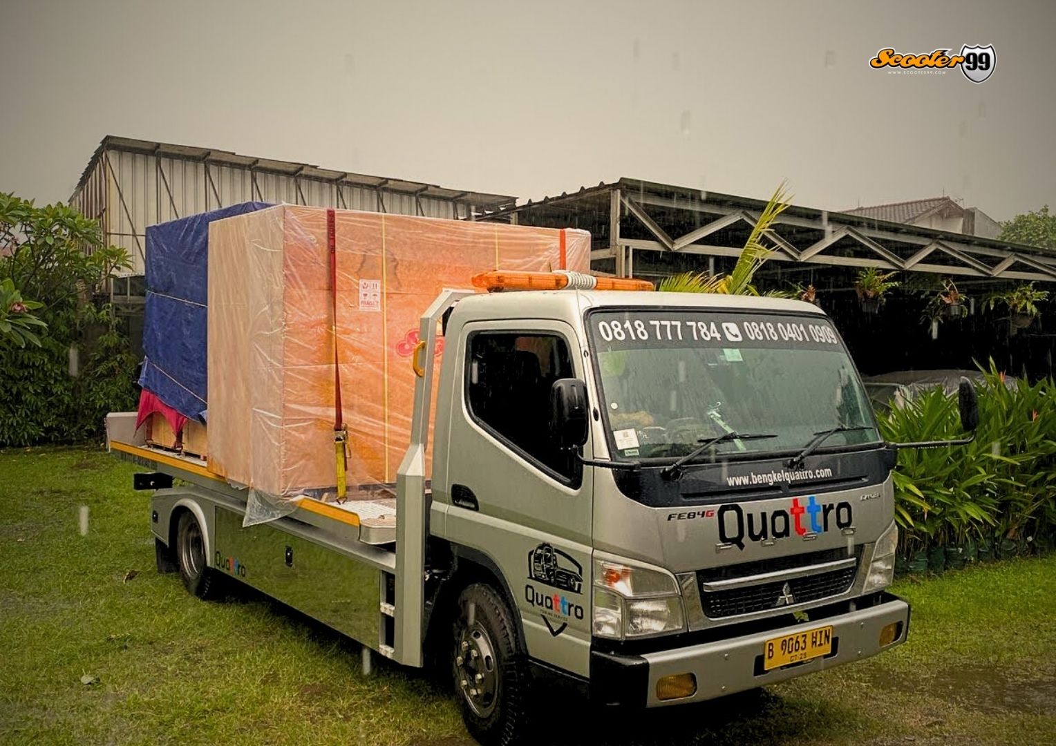Towing truck in action, securing a vehicle on the roadside